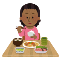 和食を食べる黒人の女性