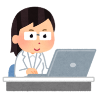 A person in a white coat (female) who works using a personal computer