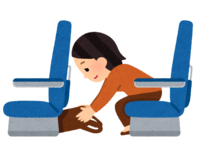 手荷物を座席の下にしまう乗客