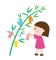 Girl hanging a strip of paper on the bamboo decoration of Tanabata