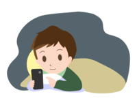A man looking at a smartphone in a futon before going to bed